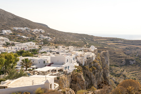 The city of Chora on Folegandros island, Greece, placed on the edge of a steep cliff atthe sunsetの写真素材