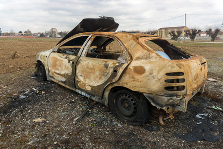 Stolen, abandoned, and burned out car.の写真素材