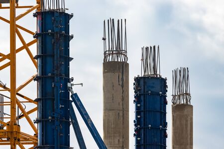 Formwork for pouring concrete .Concrete and iron pillars and frame on construction siteの写真素材