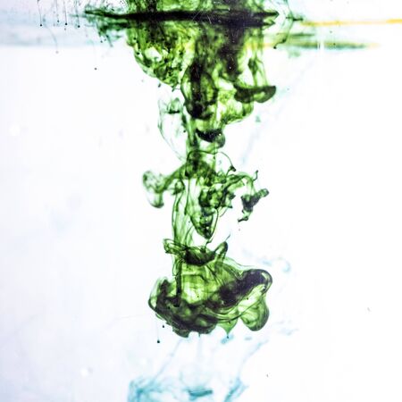 Colored ink cloud grows in water.の写真素材