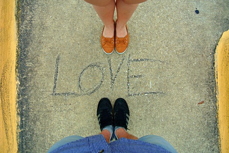 Inscription love on the street and two peopleの写真素材