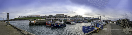 North Sunderland Harbour at Seahouses is a colourful fishing village on the North Northumberland coast in England. With its bustling harbour, it is within the Northumberland Coastal Area of Outstanding Natural Beauty. Seahouses, Northumberland, England UKのeditorial素材