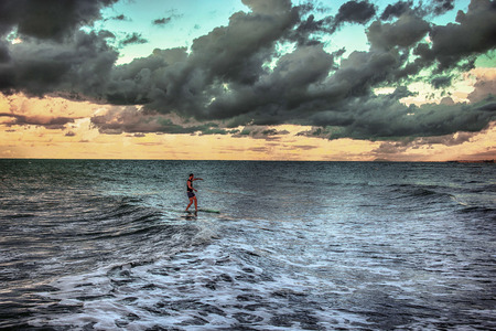 Surfer approaching land at dawnのeditorial素材