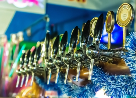 Draft beer in a colorful pubの写真素材