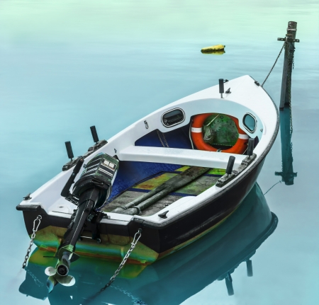 Boat docked in a small harbor in Marina di Pisa.の写真素材
