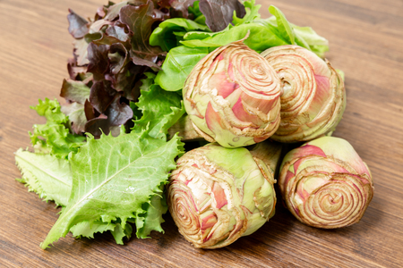 Artichokes garnished with salad ready to be eaten, both cooked and rawの写真素材