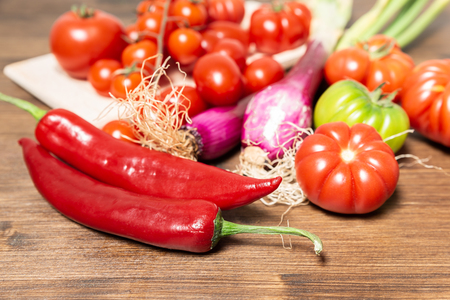 Closeup of various types of vegetables from Italy, typical of the Mediterranean diet, such as tomatoes, fresh Tropea onion (Calabria) and Sicilian spicy chili.の写真素材