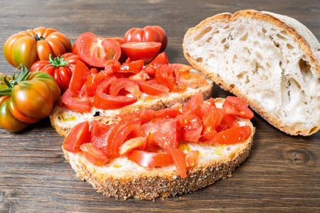 Bread oil and tomato. Appetizing very fresh food typical of the Mediterranean diet, seasoned with the addition of salt and pepper.
の写真素材