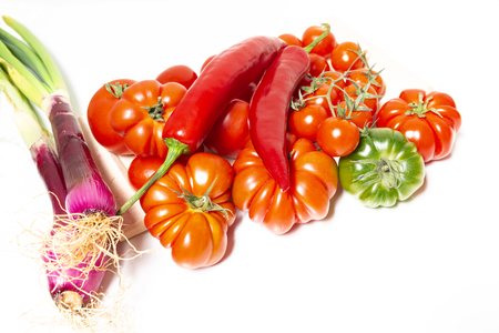 Closeup of various types of vegetables from Italy, typical of the Mediterranean diet, such as tomatoes, fresh Tropea onion (Calabria) and Sicilian spicy chili.の写真素材