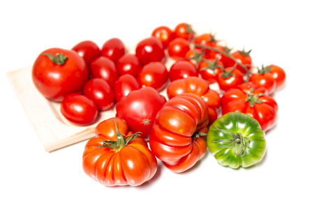 A composition of various types of tomatoes, such as the Florentine Costoluto, the cherry and the datterino. Typical in the Mediterranean diet tomatoes are native to central America.の写真素材