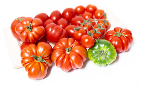 A composition of various types of tomatoes, such as the Florentine Costoluto, the cherry and the datterino. Typical in the Mediterranean diet tomatoes are native to central America.の写真素材