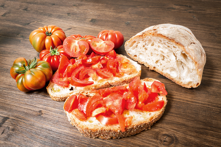 Bread oil and tomato. Appetizing very fresh food of the Mediterranean, seasoned with salt and pepper.の写真素材
