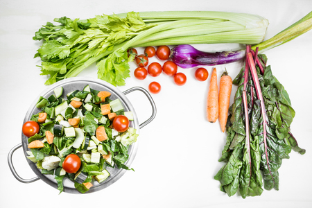 A mix of fresh vegetables on a table ready to be put in the pot and cooked to tasteの写真素材