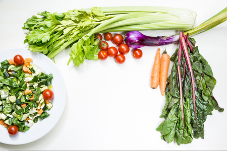 A mix of fresh vegetables on table ready to be cooked to tasteの写真素材