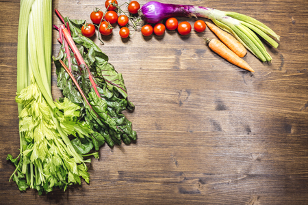 A mix of fresh vegetables on an old tableの写真素材