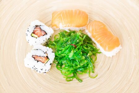 Sushi, a typical Japanese food prepared with a base of rice and various raw fish such as tuna, salmon, shrimp and sea bass.の写真素材