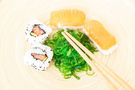 Sushi, a typical Japanese food prepared with a base of rice and various raw fish such as tuna, salmon, shrimp and sea bream. To which is added, according to the variants, the nori algae, cheeses and avocados.の写真素材