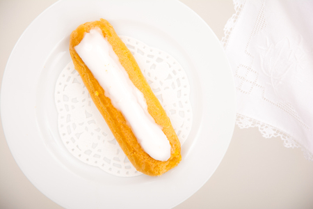 High angle view of a French vanilla pastry on white plate and background