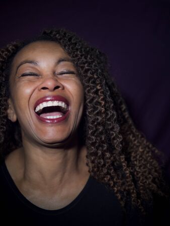Vertical portrait of an Afro American woman laughing