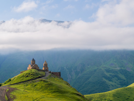 Gergeti Tsminda Sameba church near Kazbegi (Stepancminda) village, Georgia, Caucasus.
