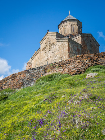 Gergeti Tsminda Sameba church near Kazbegi (Stepancminda) village, Georgia, Caucasus.