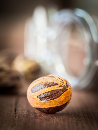 Whole nutmeg on a wooden tableの写真素材