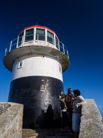 Tourists visit the old lighthouse at the top of Cape Point in South Africa.のeditorial素材