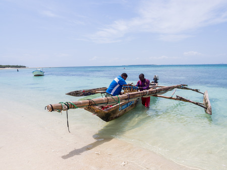 Fishermen and their boat on Mbudya Island in Tanzania, on a Sunday afternoon.