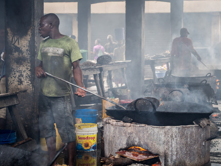 Local people frying fish on the fish market in the port in Dar es Salaam, Tanzania, East Africa, on a weekend. Horizontal orientation.のeditorial素材
