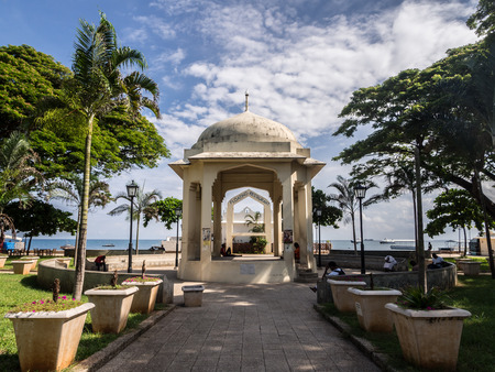 People resting in Forodani park (Forodani gardens) in Waterfront in Stone Town, Zanzibar, East Africa, on a weekend.のeditorial素材
