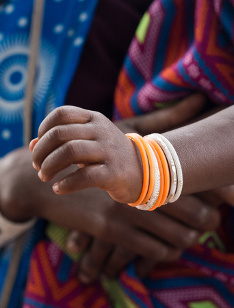 Traditional bracelets on a hand od a Maasai child in Tanzania, Africa. Close up.の写真素材