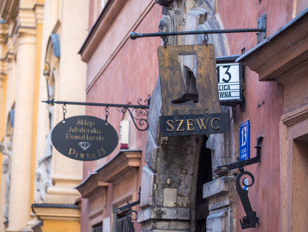 Sign reading cobbler on Piwna street in the Old Town of Warsaw, Poland.のeditorial素材