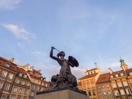 Syrenka mermaid sculpture on Warsaw's Old Town Market Place on a late summer afternoon. Wide angle, horizontal orientation.のeditorial素材