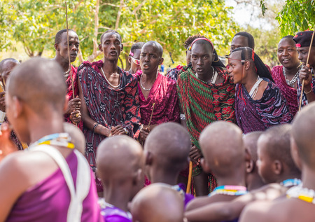 Maasai young man dancing and singing during the ceremony of transition into a new age-set for young boys and girls in Tanzania.のeditorial素材