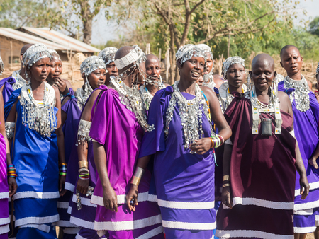 Maasai women dancing and singing during the ceremony of transition into a new age-set for young boys...