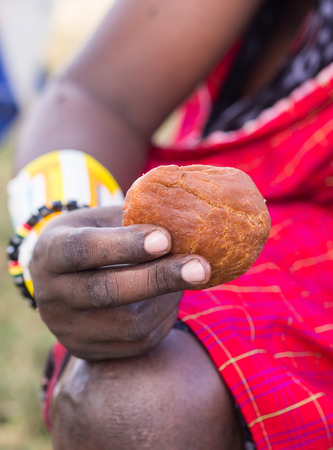Mandazi, African doughnut held by a Maasai warrior.の写真素材