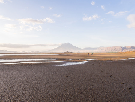 Ol Doinyo Lengai Mountain of God in the Maasai language, an active volcano in the Northern Tanzania, seen from the dried Lake Natron at sunset in October.の写真素材