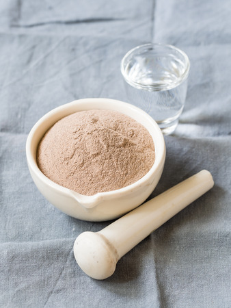 Cosmetic rhassoul clay powder in mortar.の写真素材