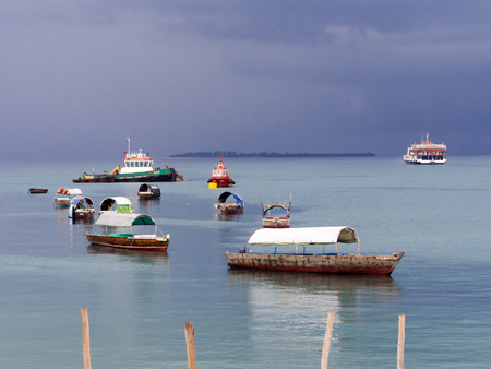 Boats close to Zanzibar on the Indian Ocean right before a storm. Heavy clouds in the background.のeditorial素材