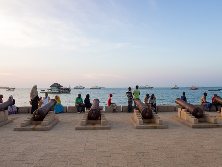 Cannons in the Waterfront of Stone Town, Zanzibar. Local people and tourist enjoy a worm evening in the Waterfront.のeditorial素材