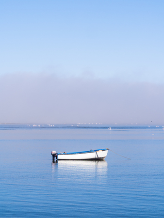 Single boat on the Atlantic Ocean in Walvis Bay, in early morning light.の写真素材