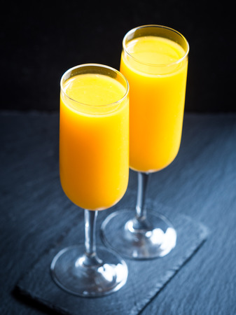 Freshly squeezed orange juice in champagne glasses.の写真素材