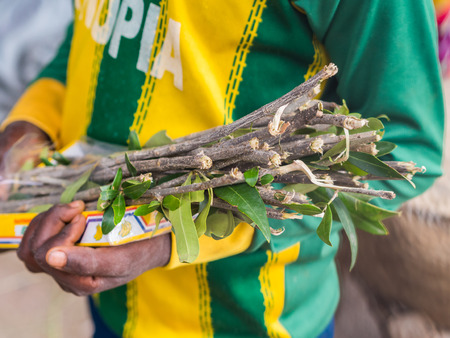 AXUM, ETHIOPIA- June 30, 2016: A boy selling mefakia, a natural wooden toothbrush used in Ethiopia.のeditorial素材