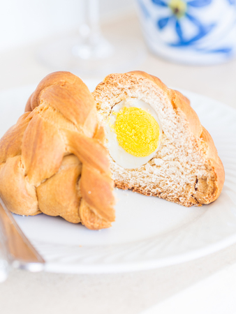 Folar, a traditional Portuguese Easter bread with a whole egg inside.