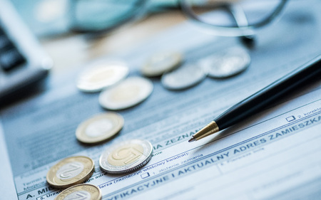 Coins, pen, calculator, glasses on the form - PITの写真素材