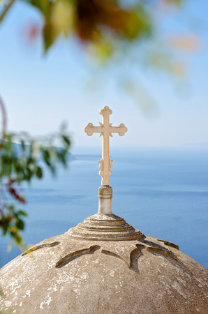 Cross on the church dome in Santorini, Cyclades, Greeceの写真素材