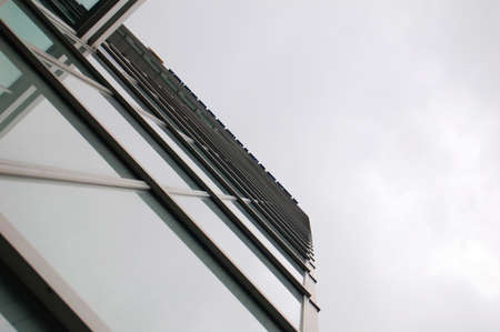 Abstract bottom view of the glass facade of a modern building with graphic lines.