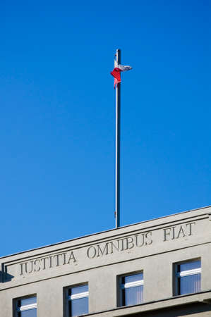 Poznan, Poland - February 12th 2022: Courthouse building against blue sky. Inscription "Justicia Omnibus Fiat" means "Let justice be done to all"のeditorial素材