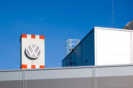 Poznan, Poland - February 13th 2022: View of the Volkswagen plant with production hall and the car factory, VW logo on the facade.のeditorial素材