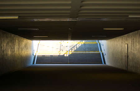 Dark underpass with staircase at the end.の写真素材